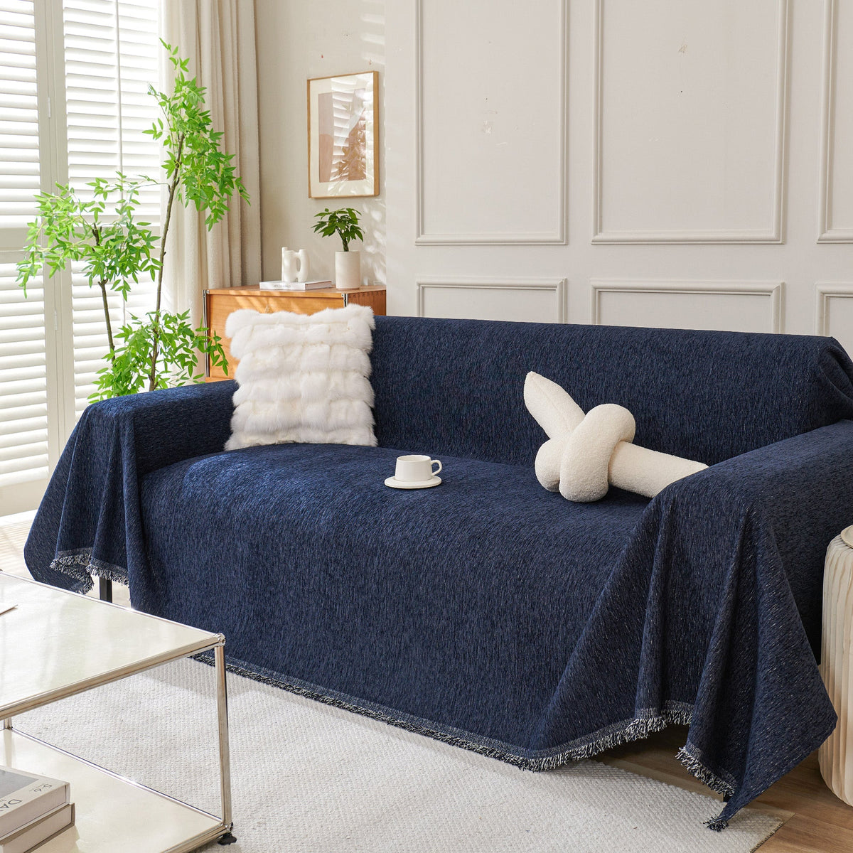Draped fringed sofa cover on a living room sofa