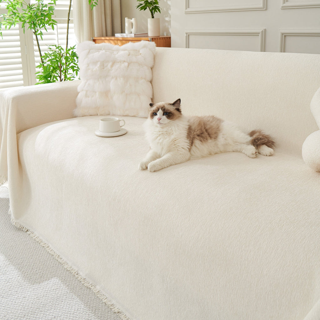 Draped fringed sofa cover on a living room sofa