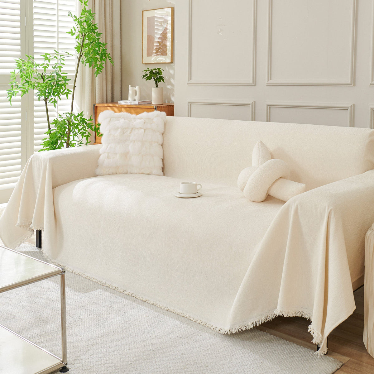 Draped fringed sofa cover on a living room sofa