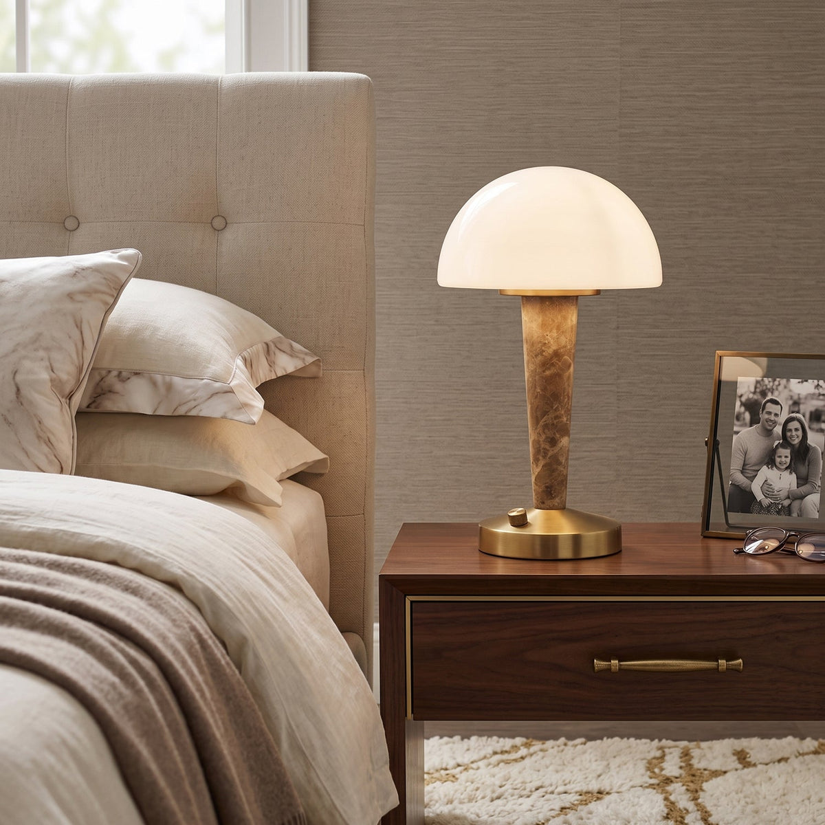 Table lamp with white dome shade, gold finish base and marble-effect stem