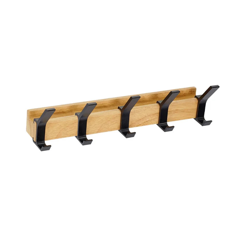 Wall-mounted coat rack with black hooks and a wood-effect rail