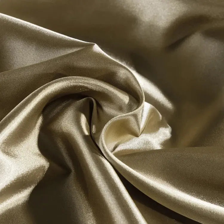 Smooth plain bedding set arranged on a bed with duvet cover, sheet and pillowcases