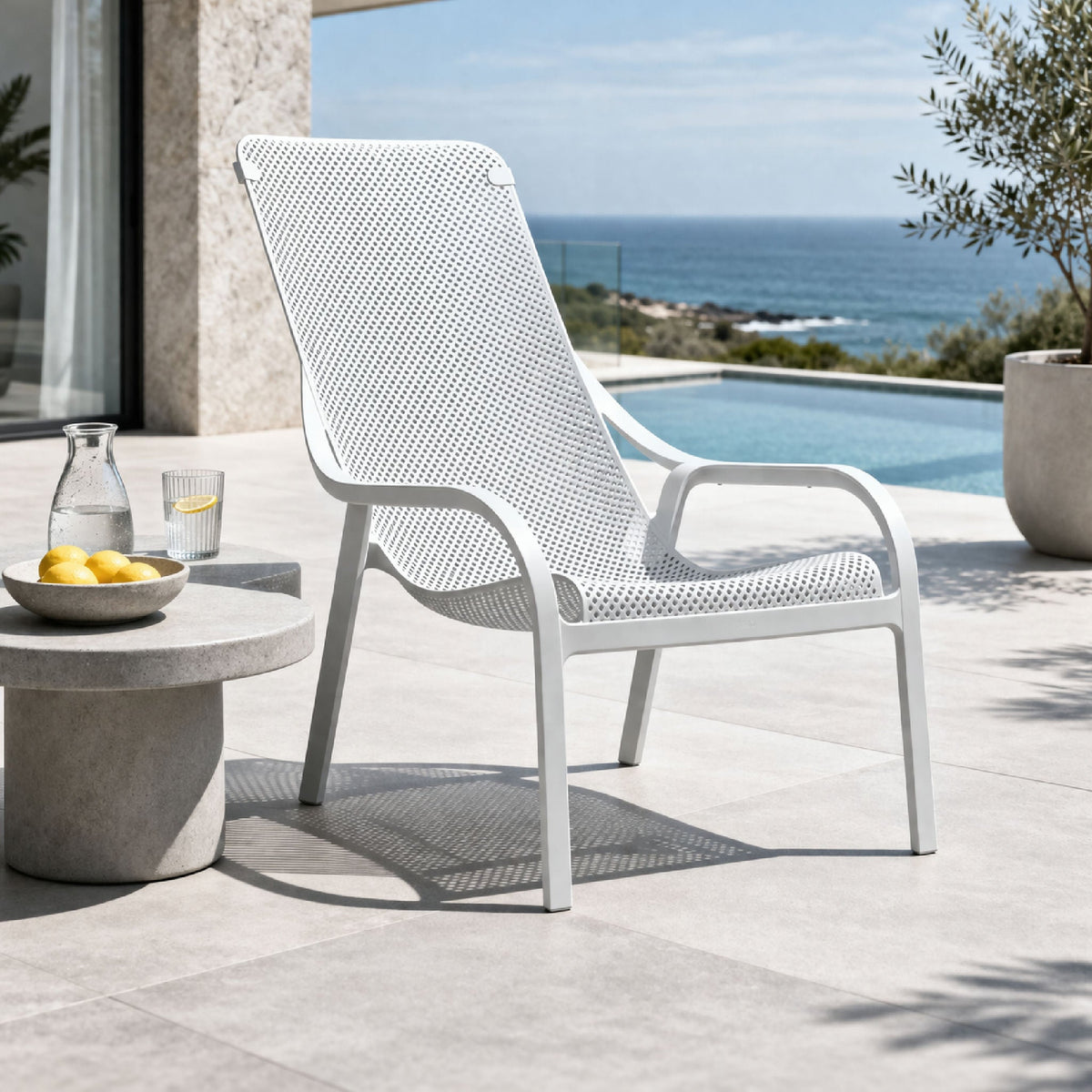 Perforated outdoor lounge chair with integrated arms and four legs