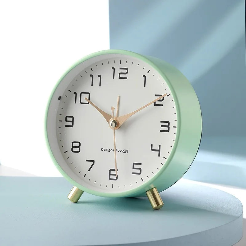 Round Scandinavian analogue table clock with numbered dial and twin feet