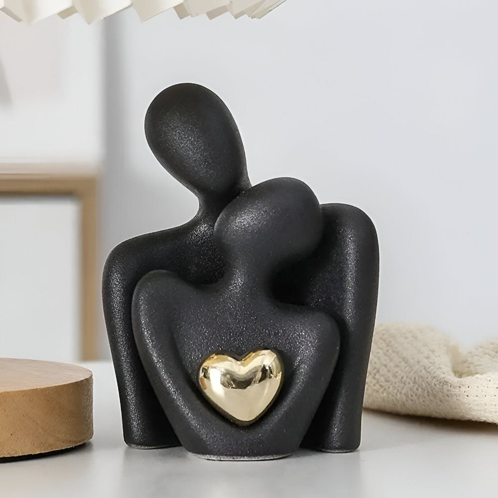 Abstract ceramic couple sculpture with metallic heart detail