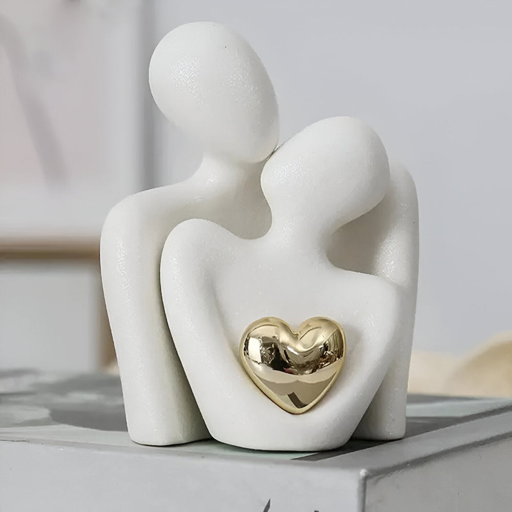 Abstract ceramic couple sculpture with metallic heart detail