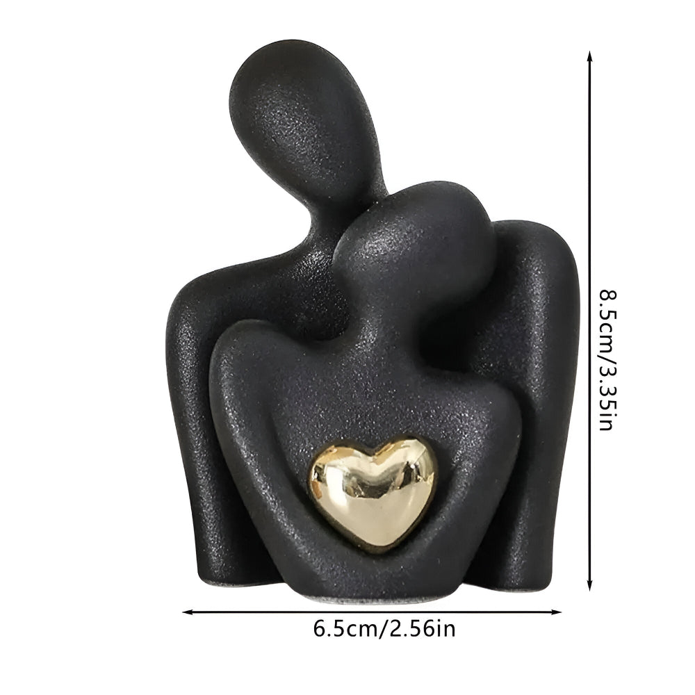 Abstract ceramic couple sculpture with metallic heart detail