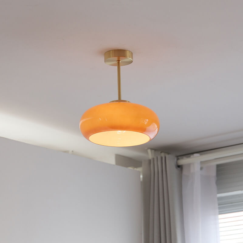 Semi-flush ceiling light with yellow rounded glass shade and brass finish