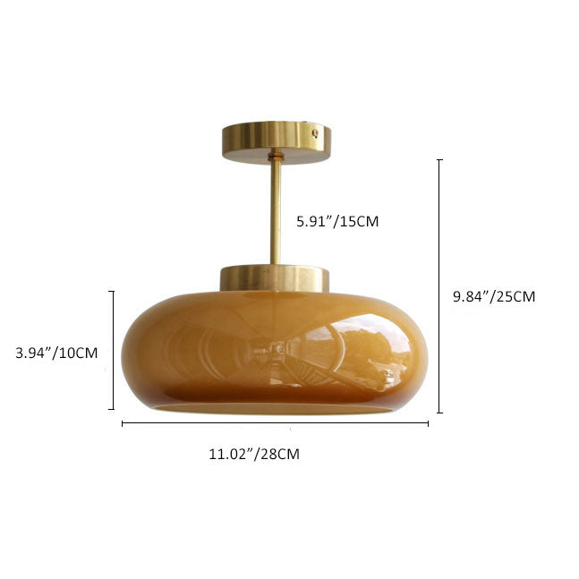 Semi-flush ceiling light with yellow rounded glass shade and brass finish