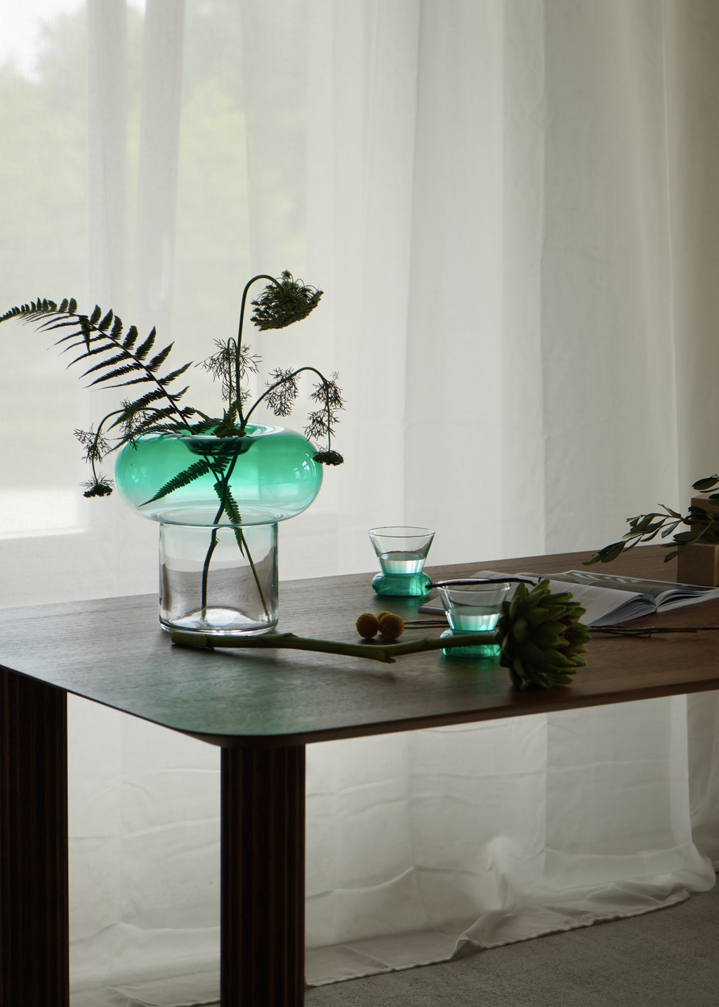 Green rounded glass vase with a clear base