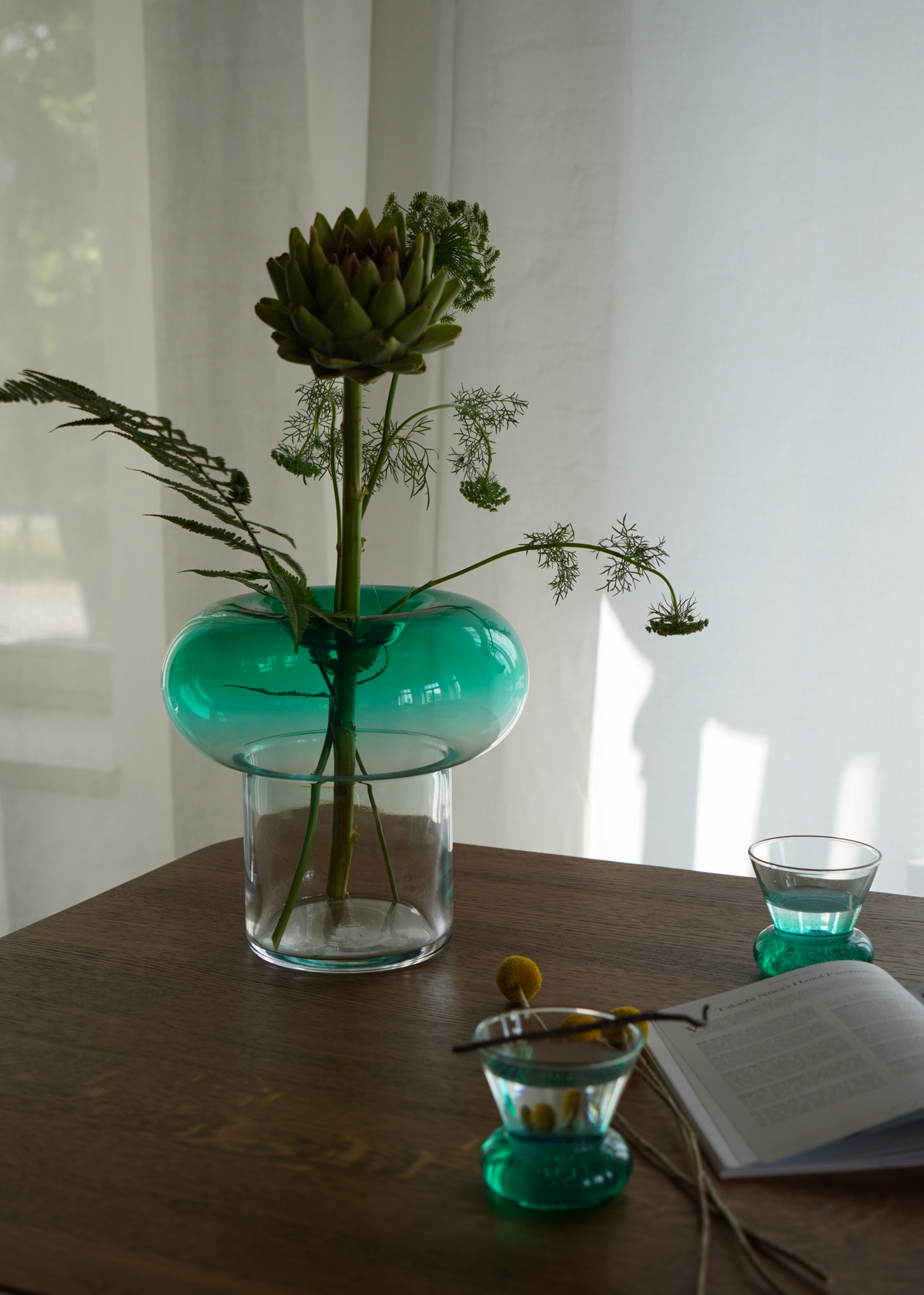 Green rounded glass vase with a clear base