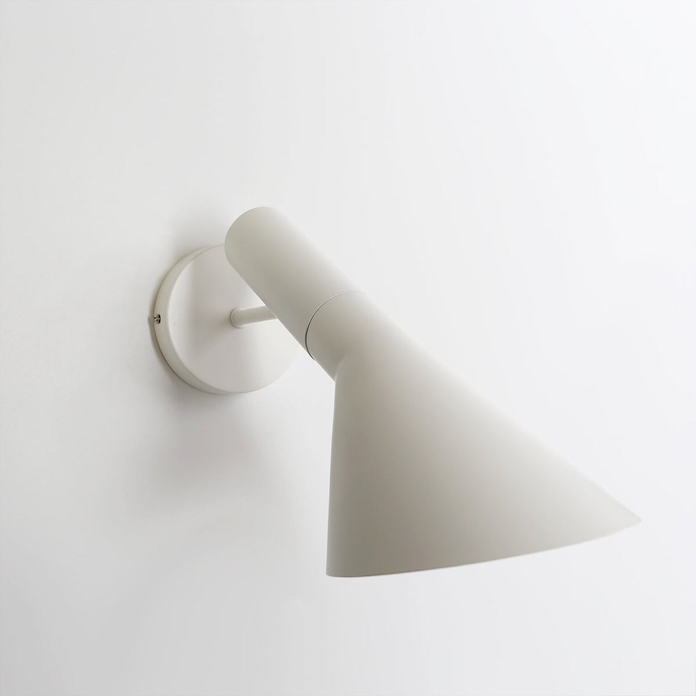 Adjustable LED wall light with a conical shade and round wall mount