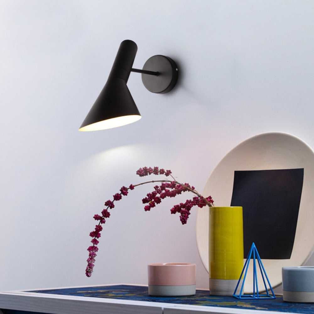 Adjustable LED wall light with a conical shade and round wall mount