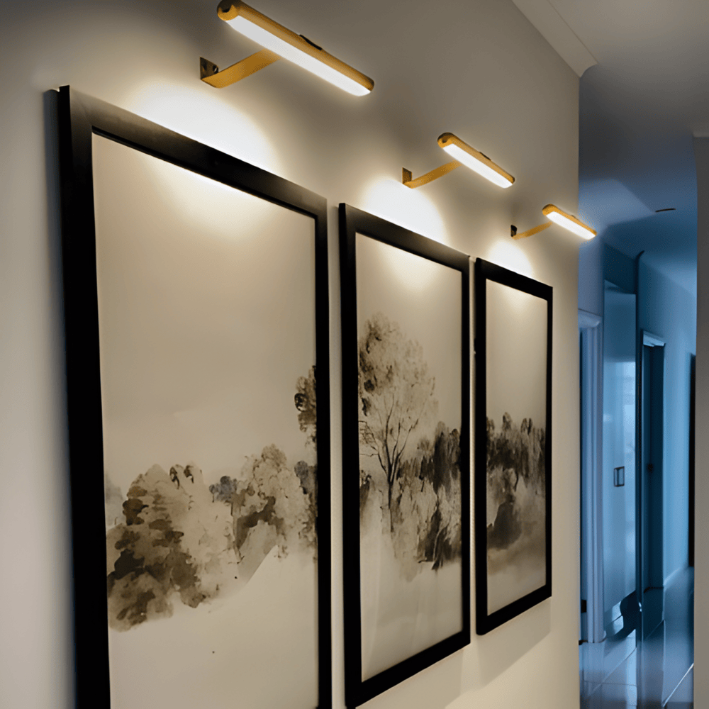 Cordless rotatable LED wall light mounted above framed artwork