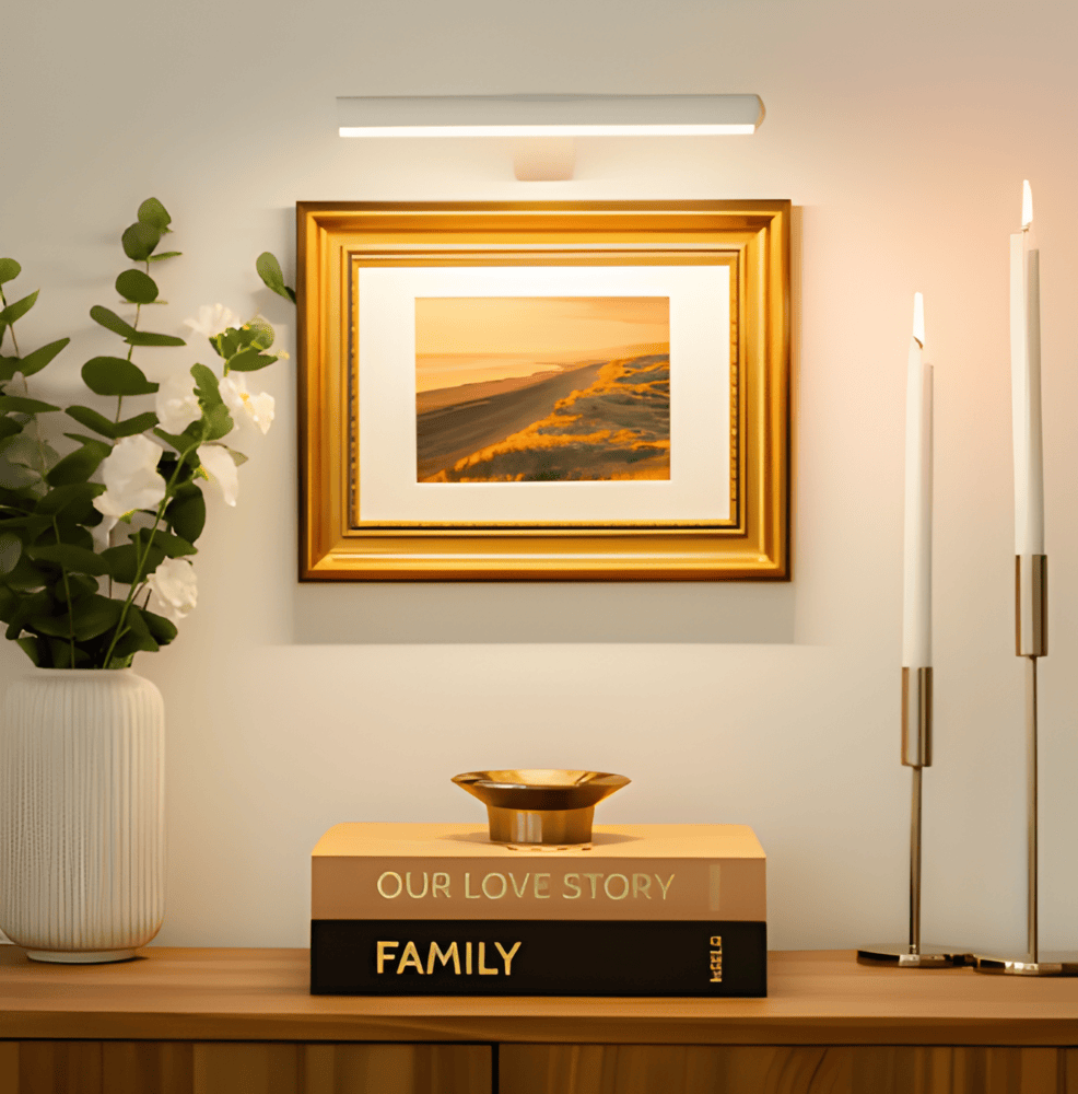 Cordless rotatable LED wall light mounted above framed artwork