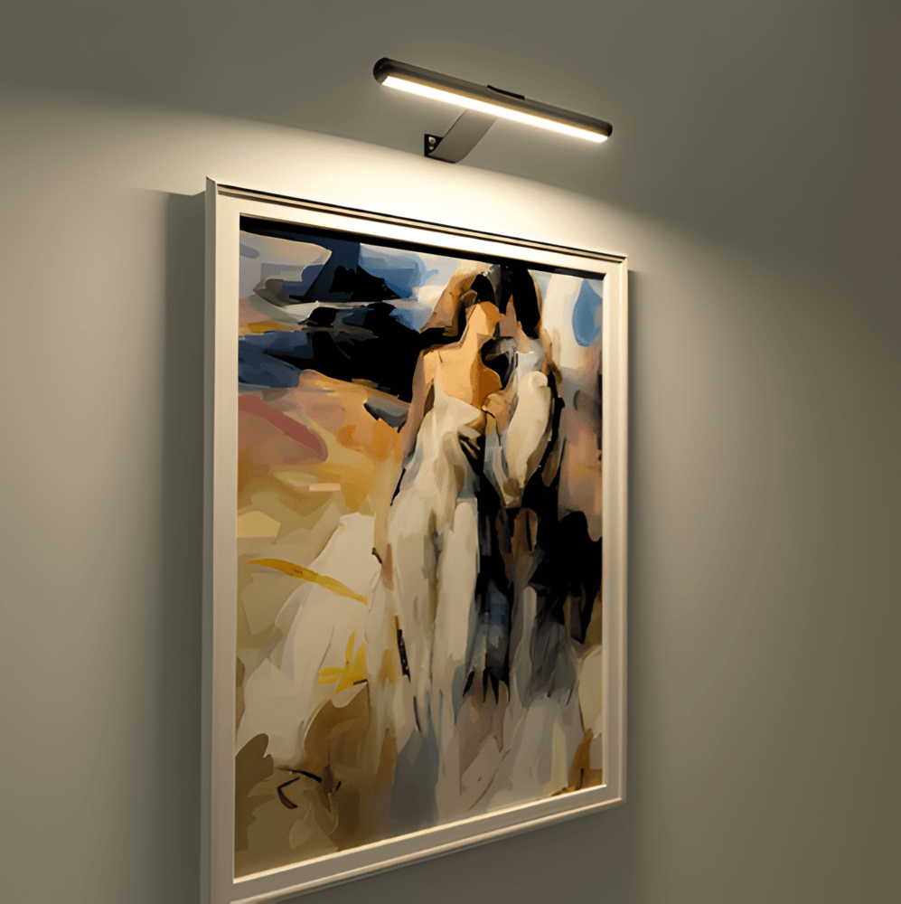 Cordless rotatable LED wall light mounted above framed artwork