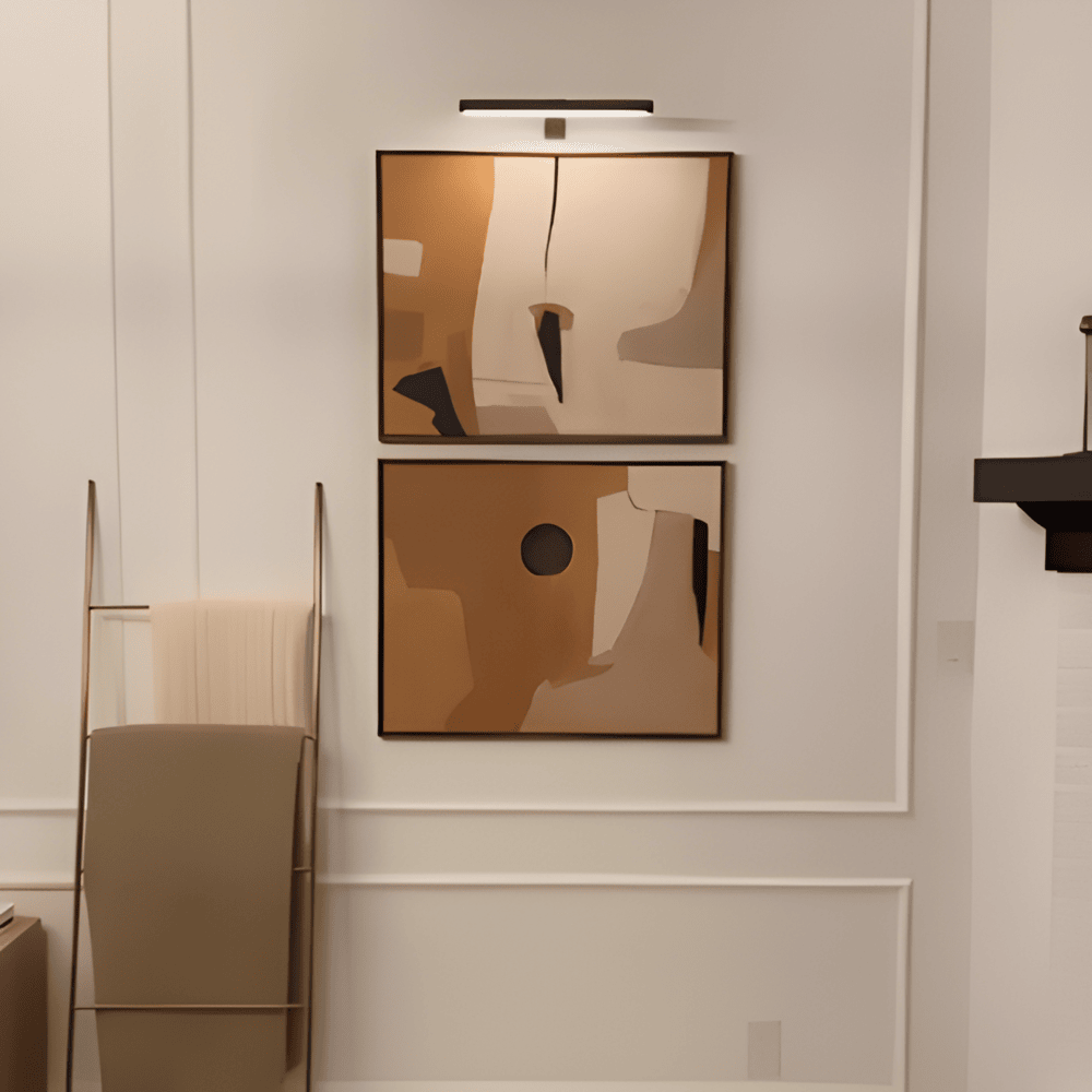 Cordless rotatable LED wall light mounted above framed artwork