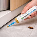 White cockroach control gel syringe with blue pointed nozzle and yellow gel
