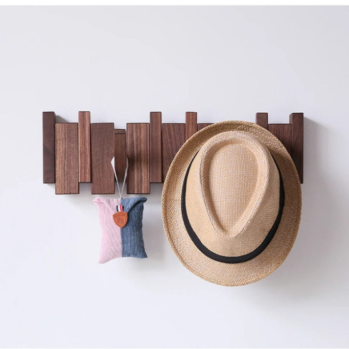 Wooden wall-mounted coat rack with multiple angled hooks