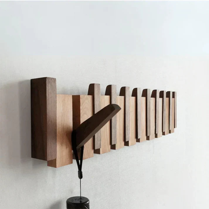 Wooden wall-mounted coat rack with multiple angled hooks
