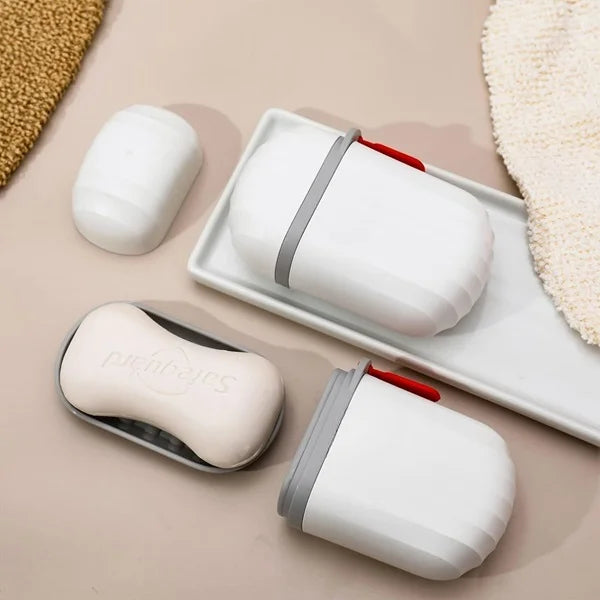 White portable soap case with grey band and red latch