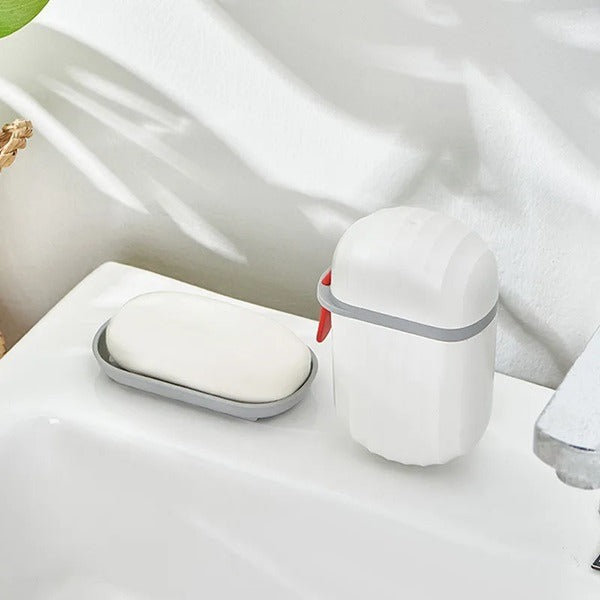 White portable soap case with grey band and red latch