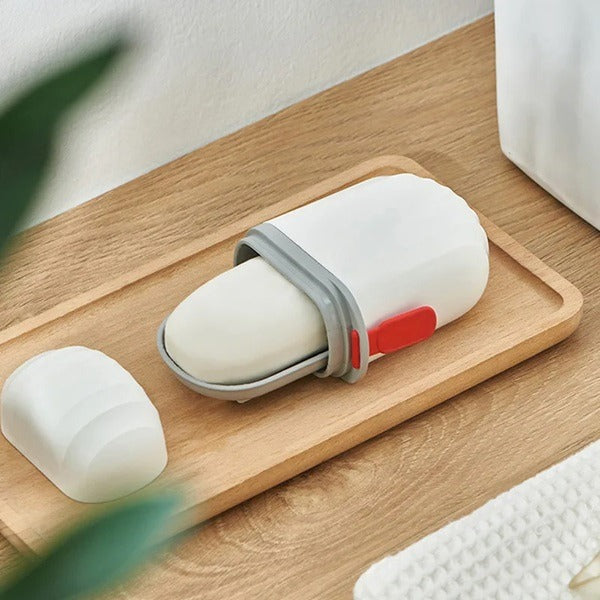 White portable soap case with grey band and red latch