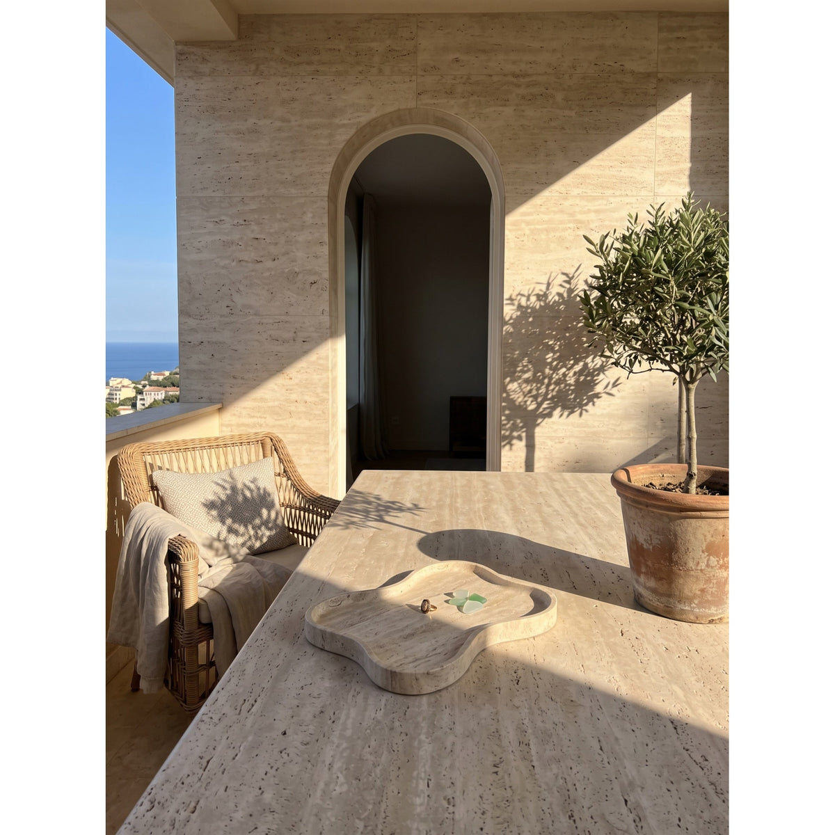 Beige organic-shaped stone decorative tray with raised edge