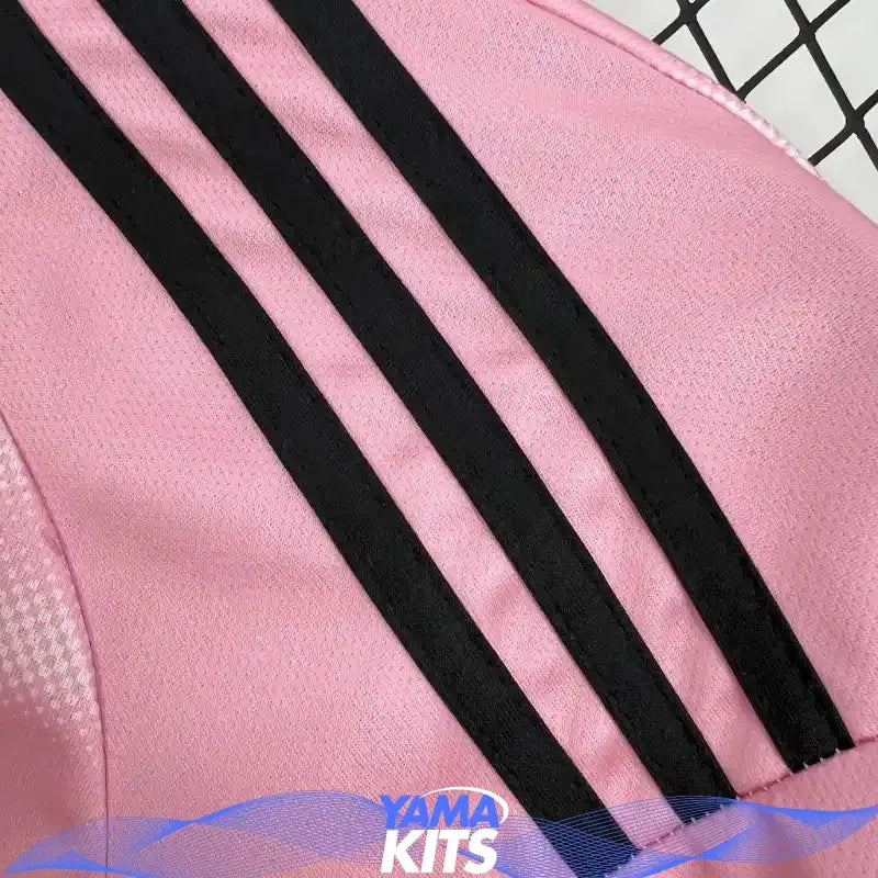 Pink Real Madrid football jersey with abstract pattern and black trim