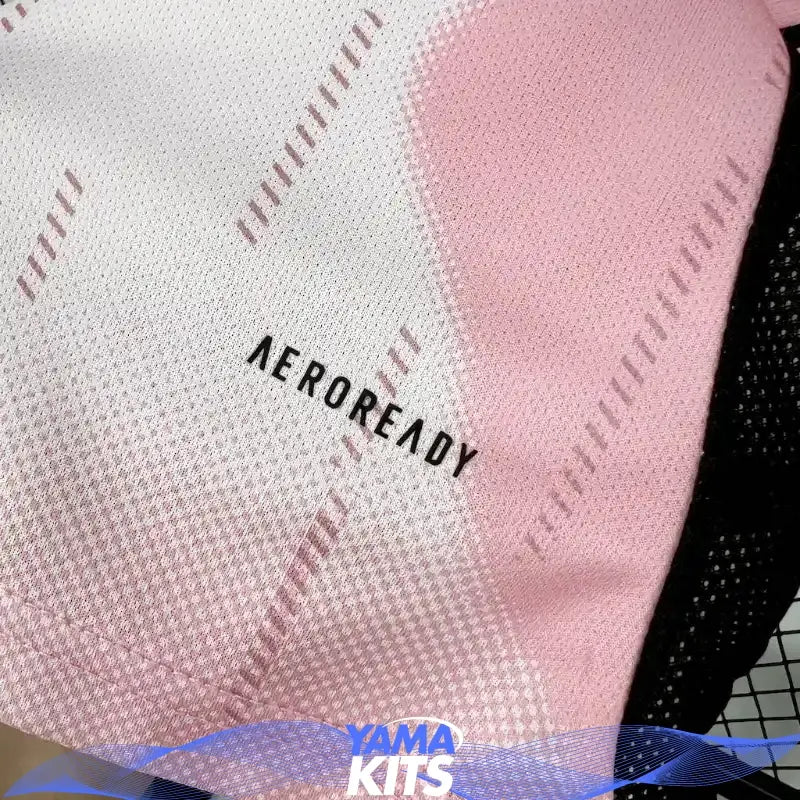Pink Real Madrid football jersey with abstract pattern and black trim