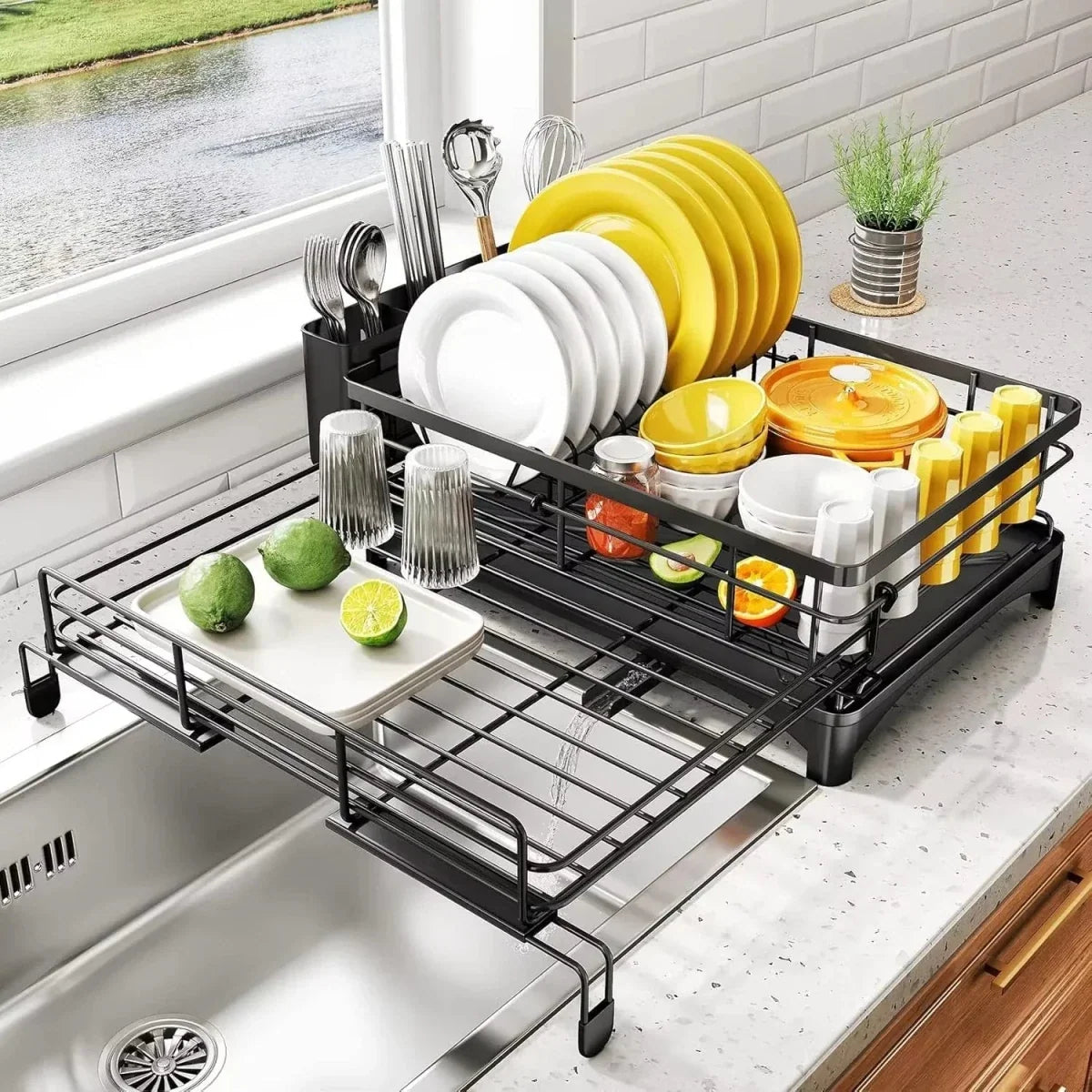 Black dish drying rack with drip tray beside a kitchen sink