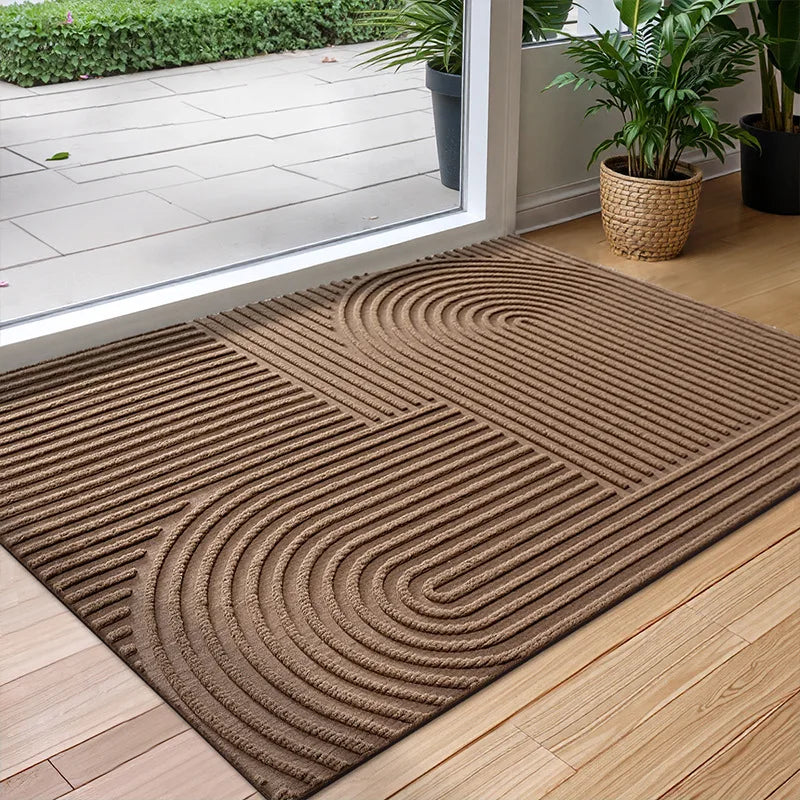 Rectangular geometric door mat with raised grooves by a glass entrance door