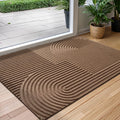 Rectangular geometric door mat with raised grooves by a glass entrance door