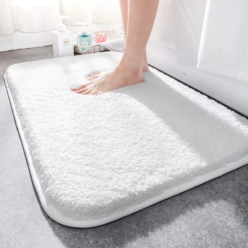 Plush rectangular bathroom mat with soft pile, rounded corners and bound edging
