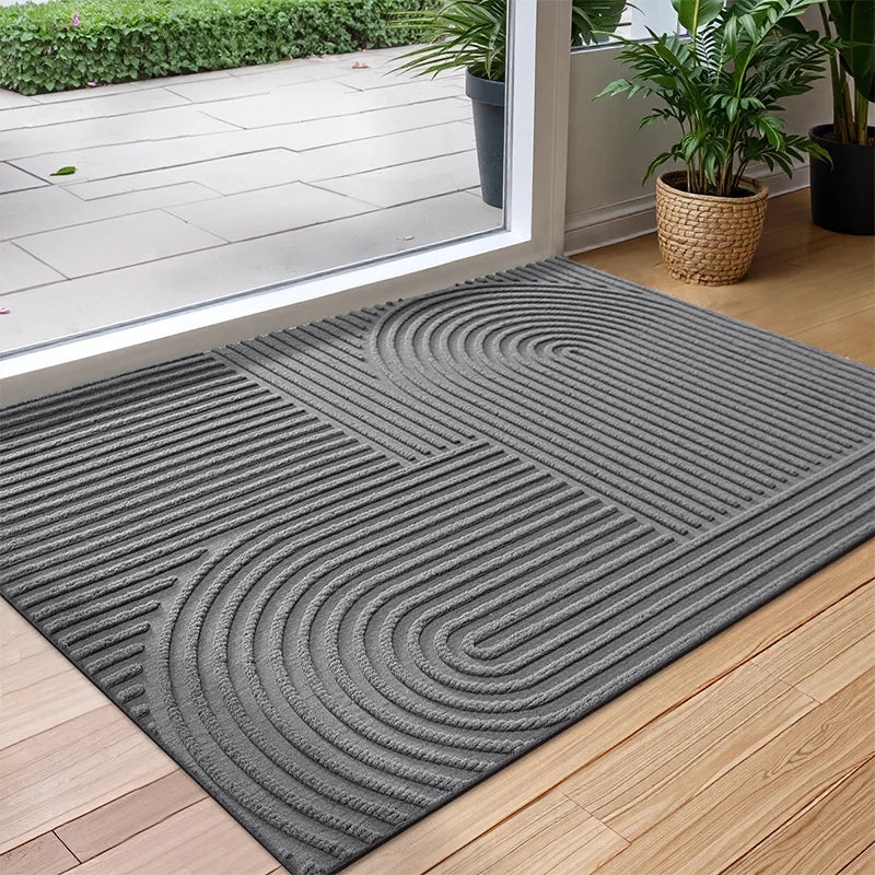 Rectangular geometric door mat with raised grooves by a glass entrance door