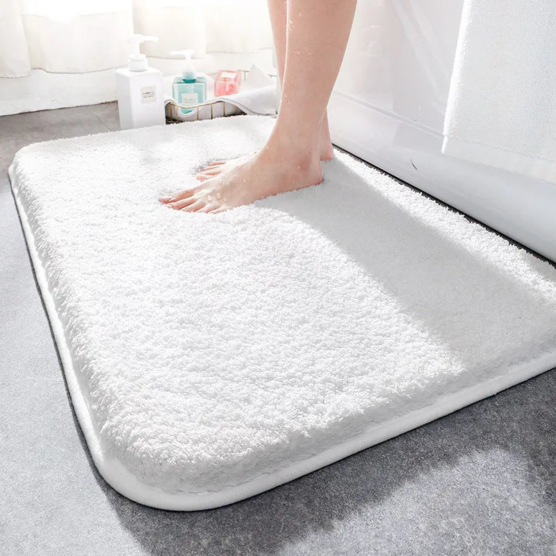 Plush rectangular bathroom mat with soft pile, rounded corners and bound edging
