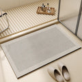 Rectangular neutral bath mat with textured surface and bordered edge