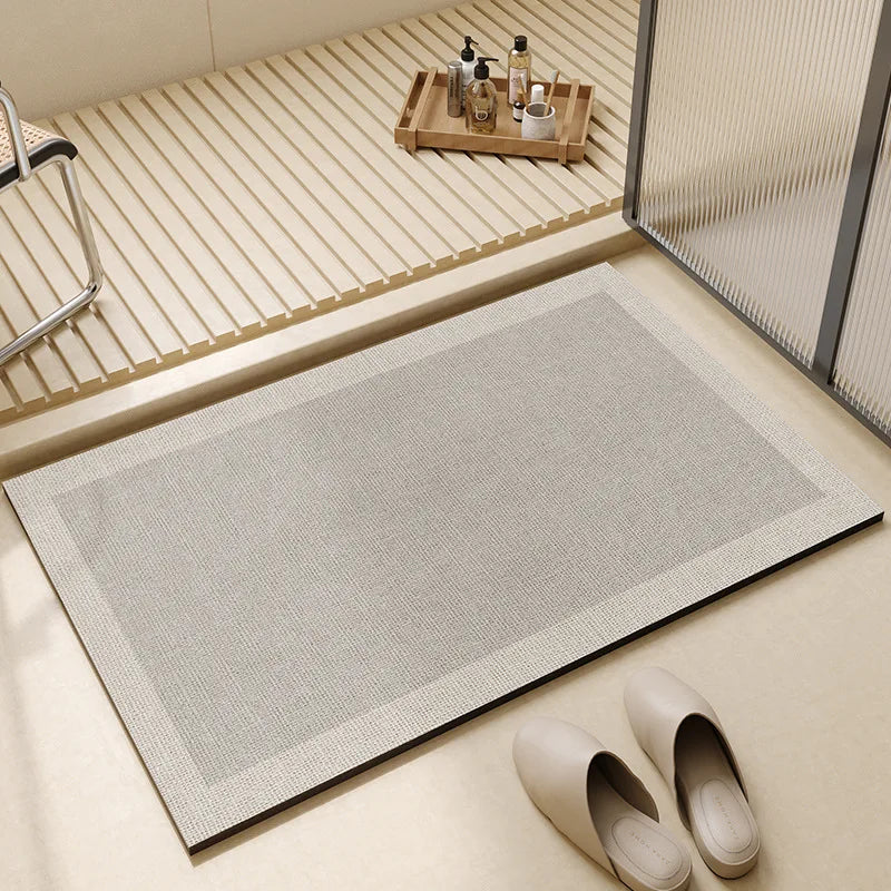 Rectangular neutral bath mat with textured surface and bordered edge