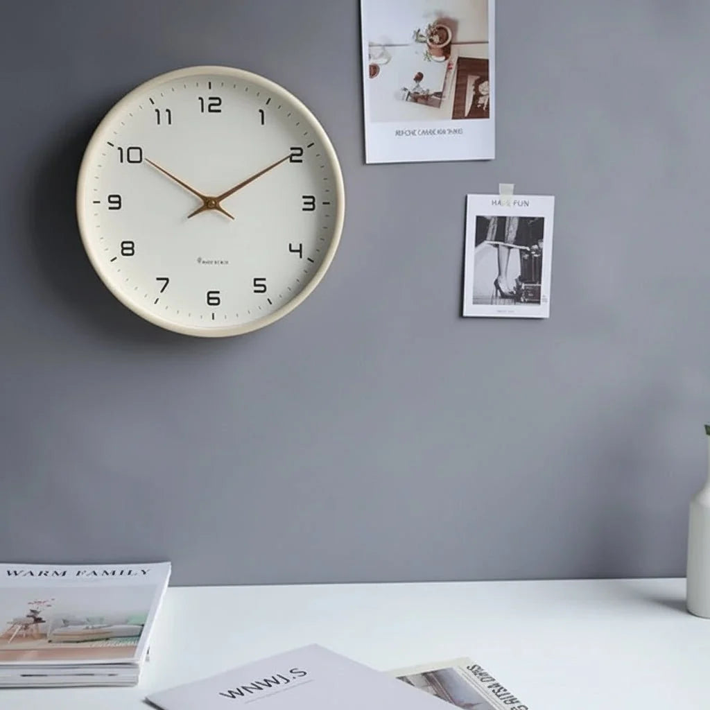 Round minimalist wall clock with large dark numerals and slim hands