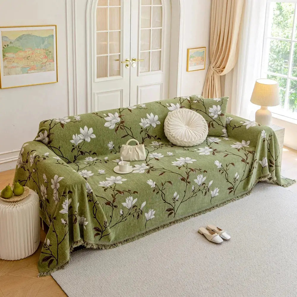 Floral sofa cover with botanical flowers, leaves and fringed edges