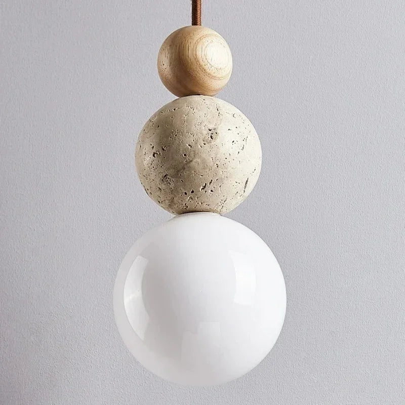 Pendant ceiling light with three stacked spherical details and a hanging cord