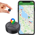 Black round magnetic GPS tracker beside a smartphone map