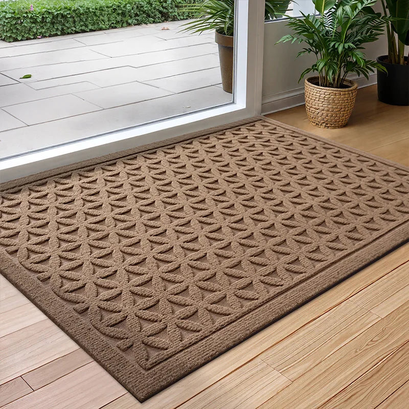 Rectangular geometric door mat with raised grooves by a glass entrance door