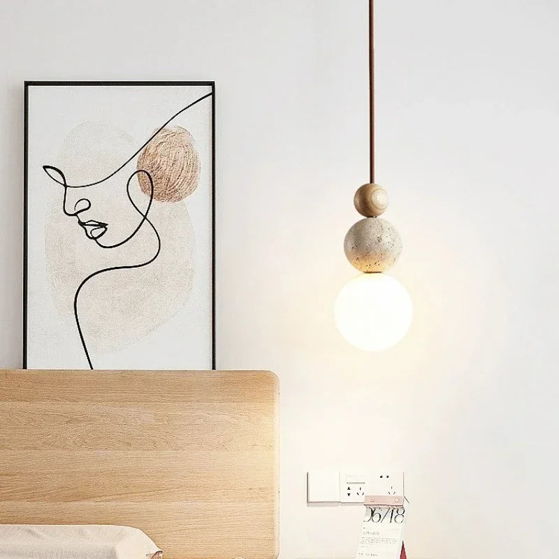 Pendant ceiling light with three stacked spherical details and a hanging cord