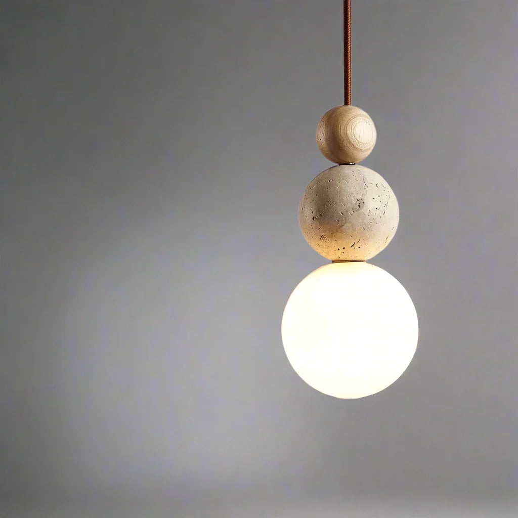 Pendant ceiling light with three stacked spherical details and a hanging cord