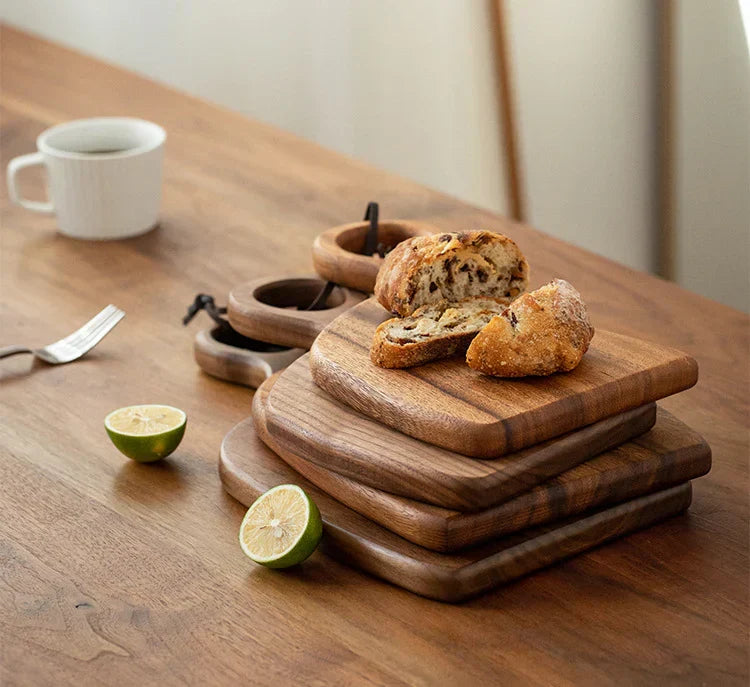 Brown walnut cutting board with shaped handle and rounded hanging hole