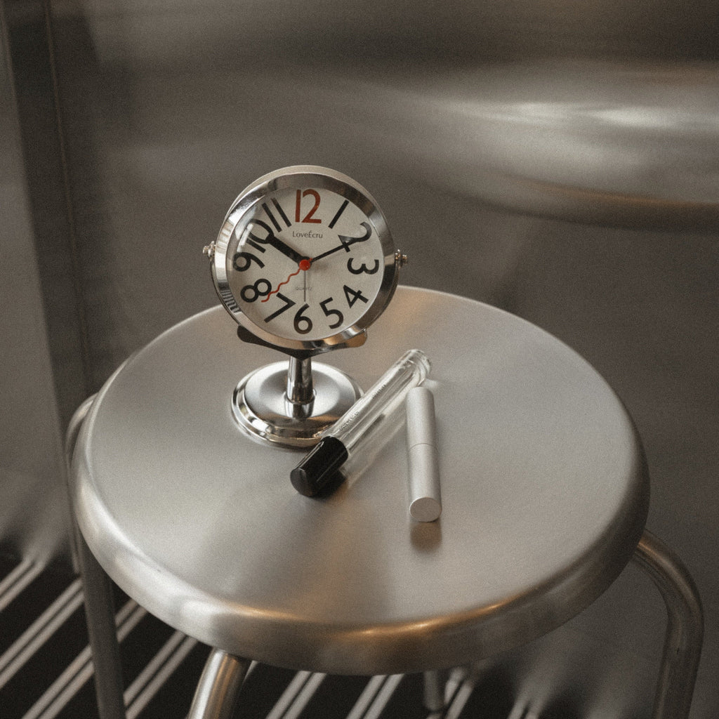 Freestanding analogue alarm clock with bold numbered dial and chrome effect stand
