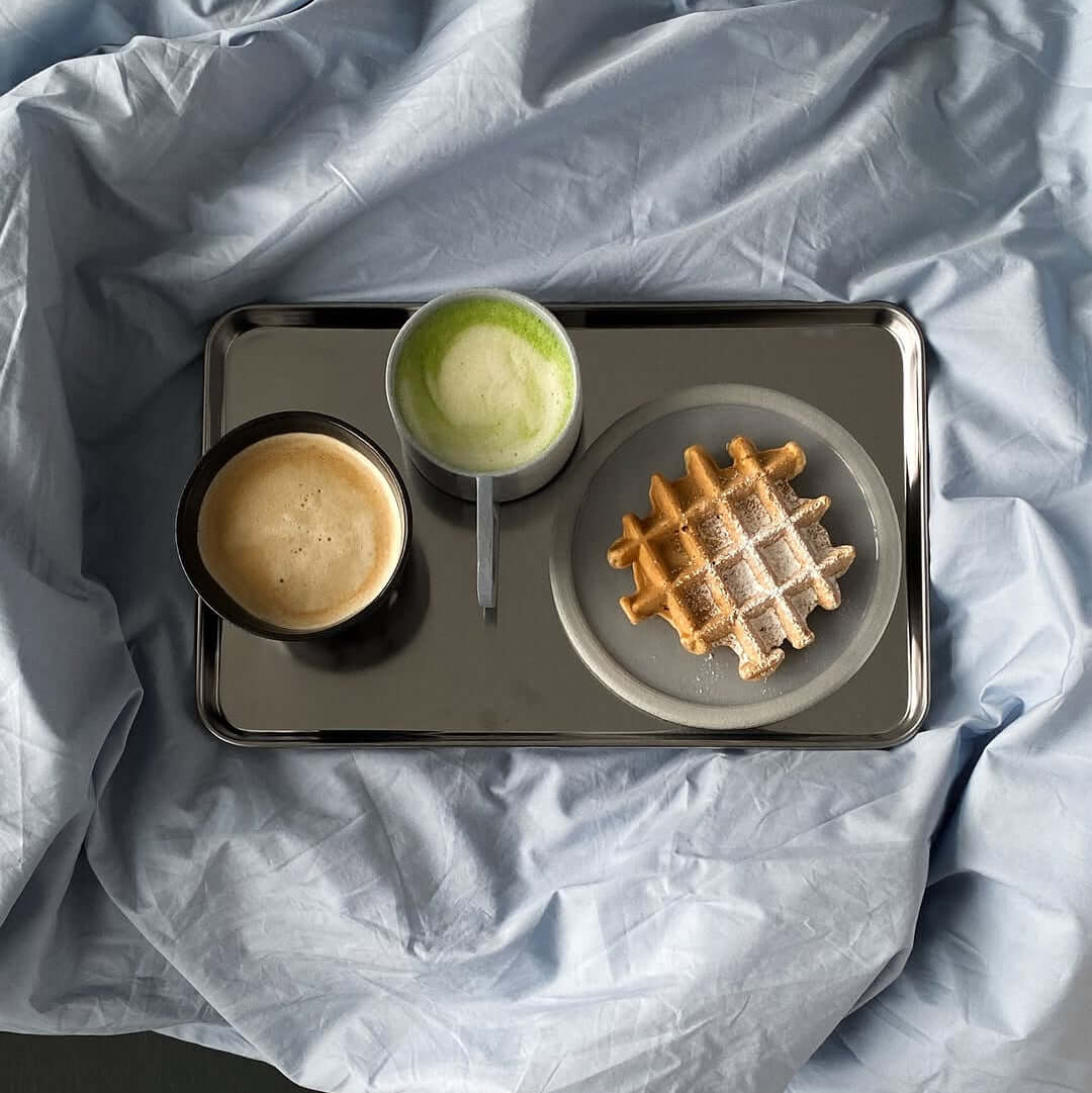 Reflective silver stainless steel serving tray with raised edge