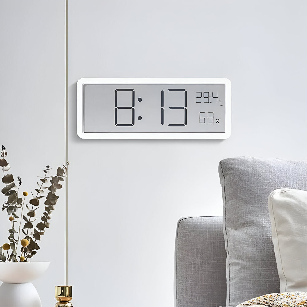 Digital wall clock displaying time, temperature and humidity