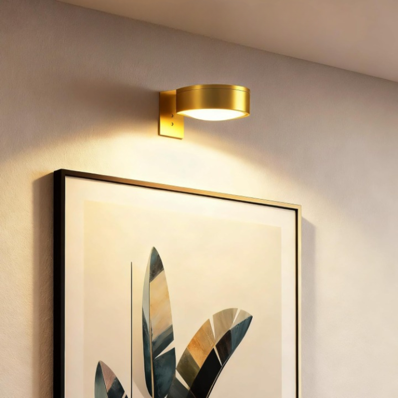 Wireless wall-mounted picture light above framed artwork with remote control